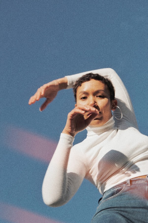 Dancer moving against a bright sky backdrop